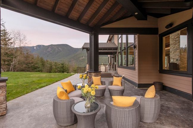 Patio terrace at dusk featuring a mountain view and a yard | Image 35