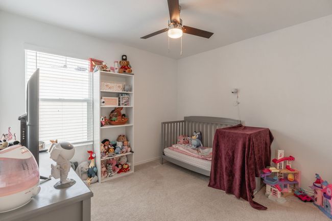 Carpeted bedroom with ceiling fan | Image 11