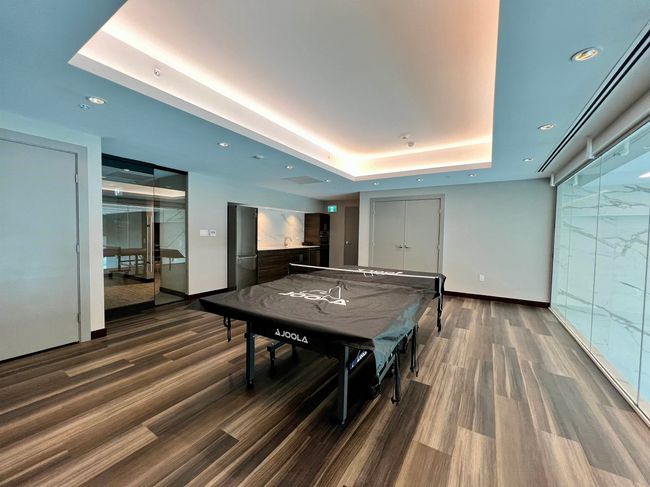 Game room with a tray ceiling, baseboards, wood finished floors, and recessed lighting | Image 17