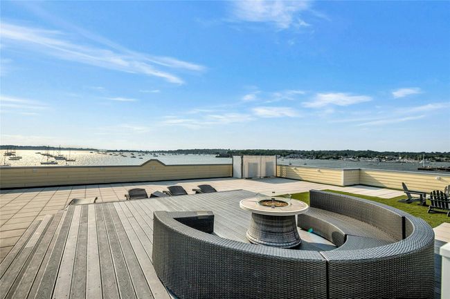 Wooden terrace featuring an outdoor fire pit | Image 30