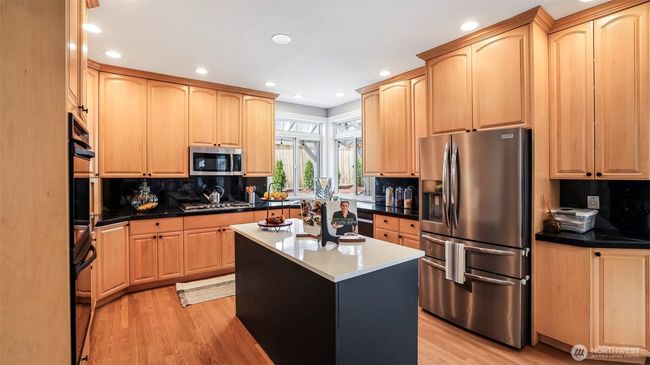 Featuring a newly painted large black island—ideal for quick meals and extra prep space—with all kitchen appliances included! | Image 20