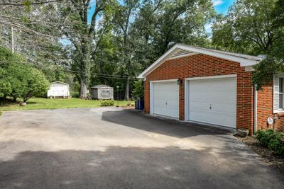 Large 2 car garage with tons of built in white cabinets | Image 2