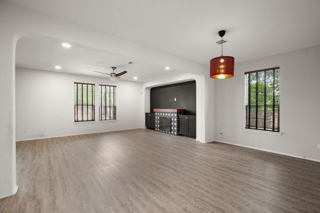 Unfurnished living room with recessed lighting, arched walkways, and wood finished floors | Image 15