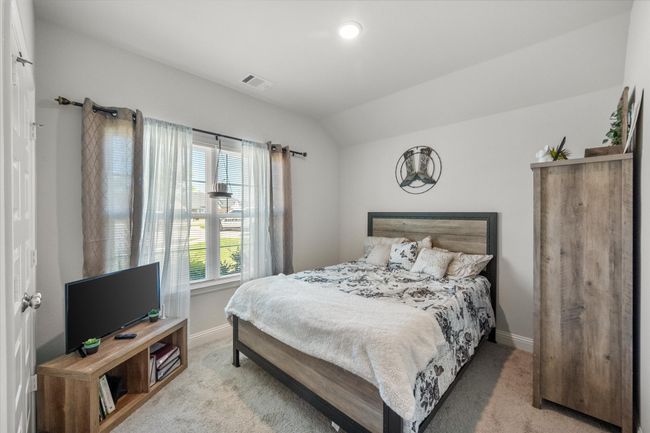 Bedroom featuring light carpet and vaulted ceiling | Image 14