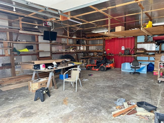 garage with a workshop area and a garage door opener | Image 39