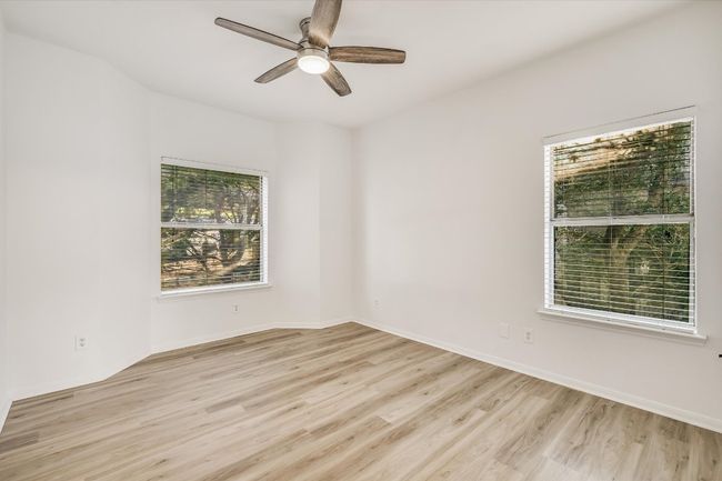 Spare room with light wood-style floors and a ceiling fan | Image 8