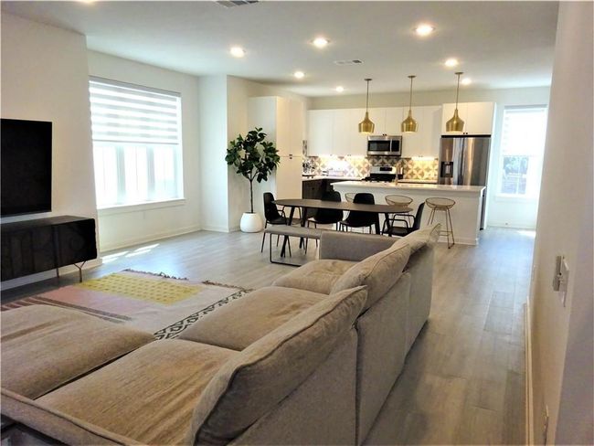 Living room with light wood finished floors, baseboards, and recessed lighting | Image 9