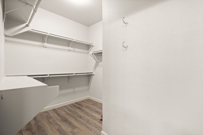 Walk in closet featuring wood finished floors | Image 19