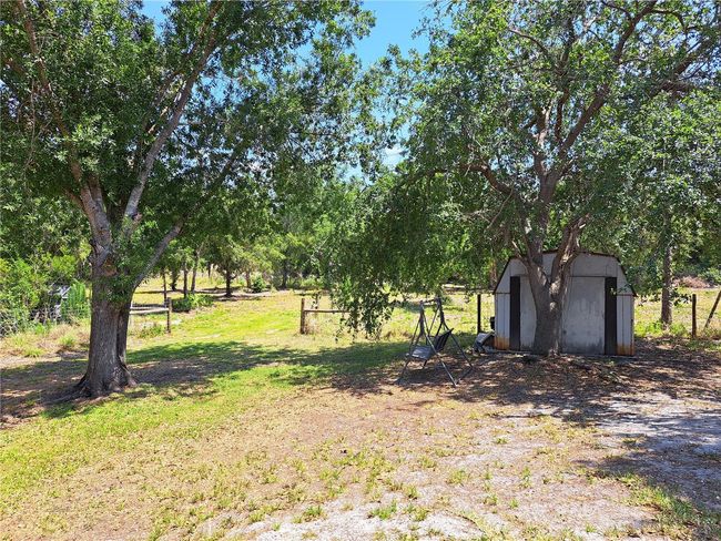 Great backyard! Shed has power and can be used by tenant. Lots of trees for shaded enjoyment. | Image 28