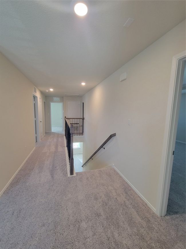 Hall with carpet, an upstairs landing, baseboards, visible vents, and recessed lighting | Image 25