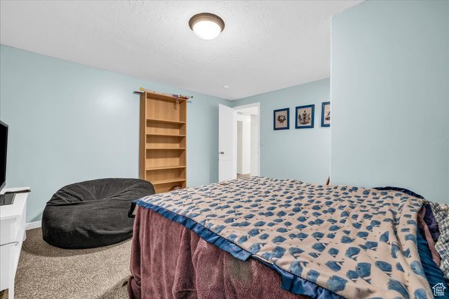 Bedroom with carpet floors and a textured ceiling | Image 16