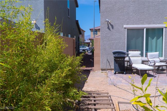 View of patio featuring a gate, grilling area, and fence | Image 65