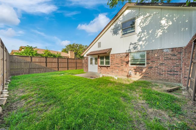 Back of house featuring brick siding and a fenced backyard | Image 24