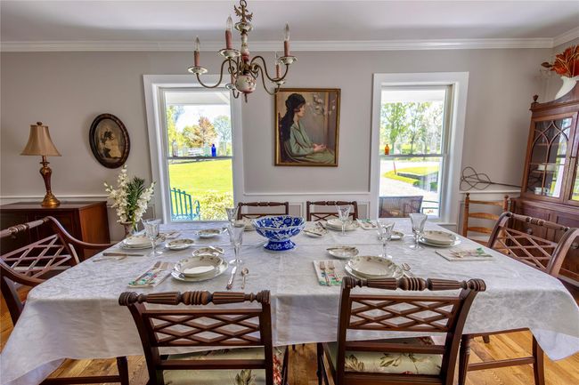 Dining room featuring a chandelier, crown molding, and wood finished floors | Image 17