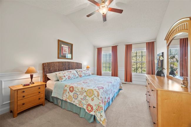 Step upstairs to find the master bedroom with vaulted ceiling. | Image 25