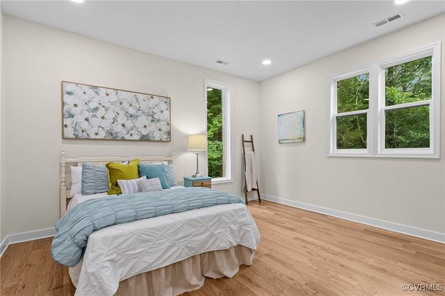 Bedroom featuring multiple windows, wood finished floors, and recessed lighting | Image 27
