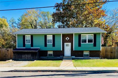 Raised ranch featuring a front lawn | Image 1