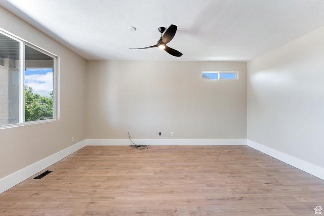 Den/front living room featuring ceiling fan and light wood-type flooring | Image 4
