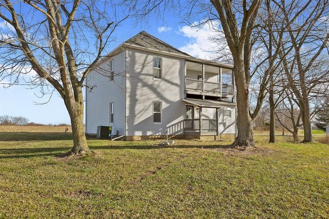 Rear view of house featuring a balcony, a yard, and central air condition unit | Image 27