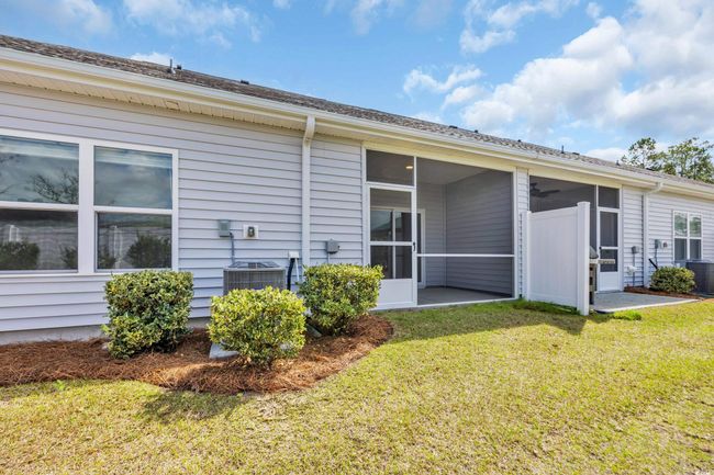 View of side of property featuring a lawn, cooling unit, and a sunroom | Image 17