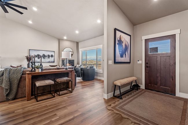 Foyer entrance featuring vaulted ceiling, wood finished floors, recessed lighting, baseboards, and ceiling fan | Image 41