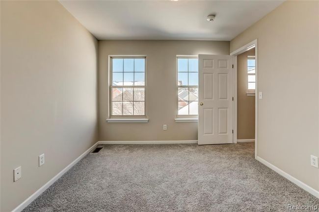 Master bedroom with dual windows to let the light shine in. | Image 13