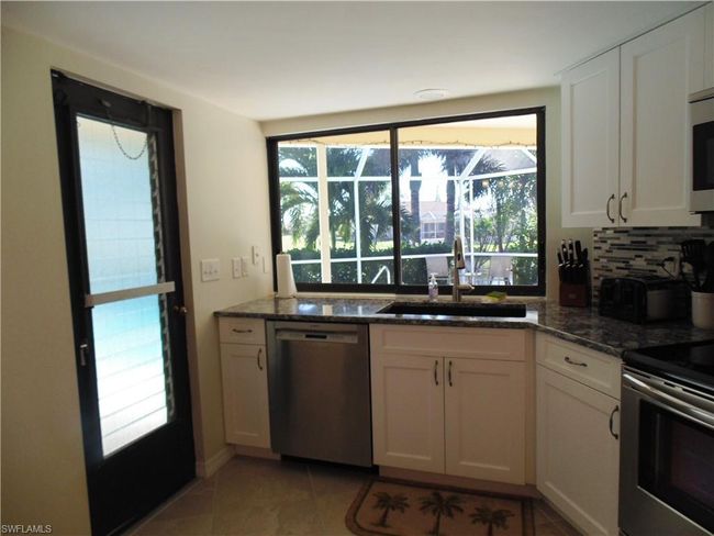 Kitchen featuring a wealth of natural light, stainless steel appliances, and a sink | Image 6