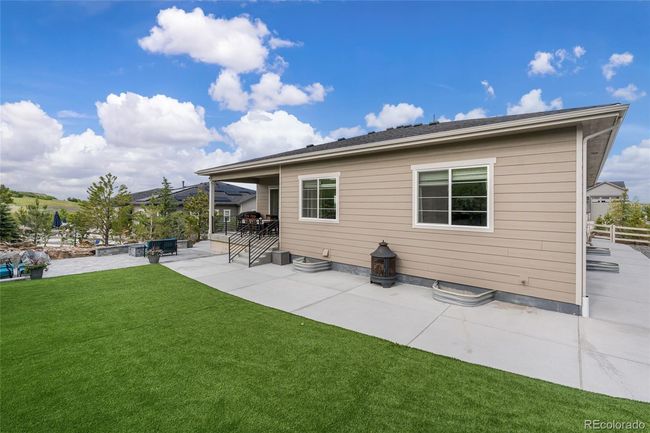 Turf area in professionally landscaped backyard | Image 43