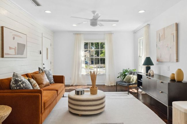 Hardwood floors, shiplap accent walls, high ceilings, and storybook windows gives this home so much character! | Image 4