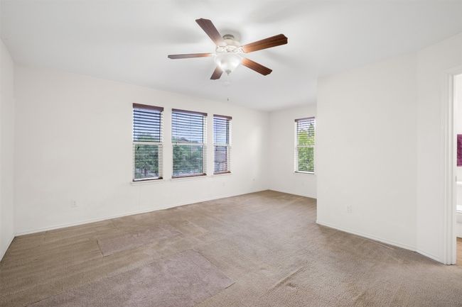 Unfurnished room featuring a ceiling fan, baseboards, and carpet | Image 21