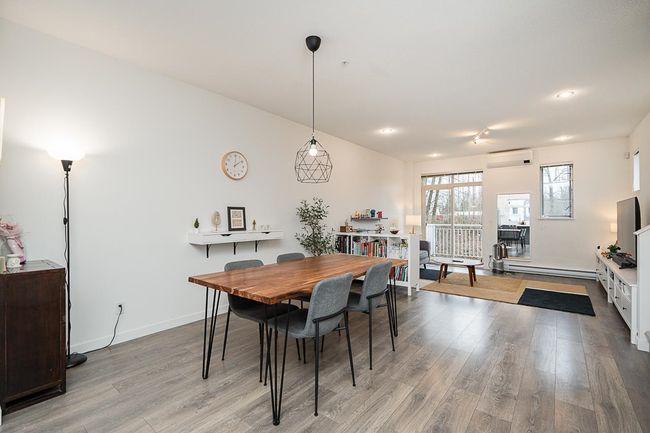 Dining area with baseboards, an AC wall unit, and wood finished floors | Image 8