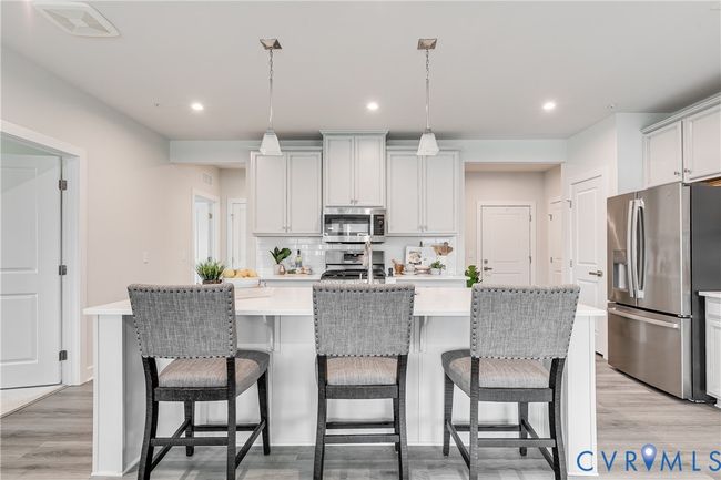 Center island doubles as a casual dining spot or prep area | Image 7