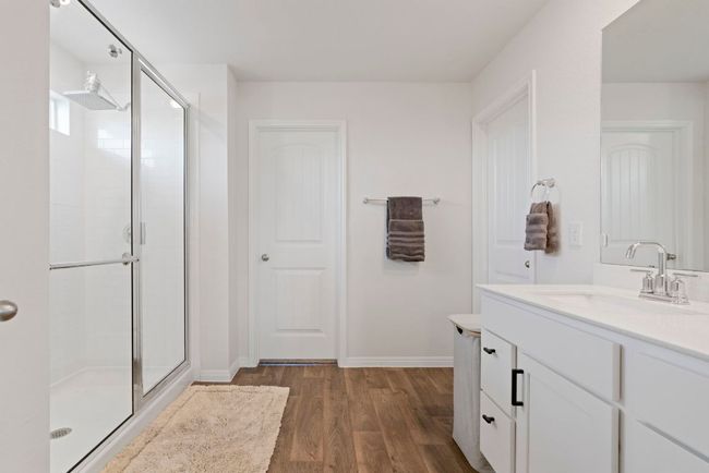 Bathroom with a stall shower, vanity, and wood finished floors | Image 21
