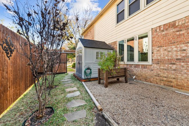 View of yard with a storage shed | Image 27