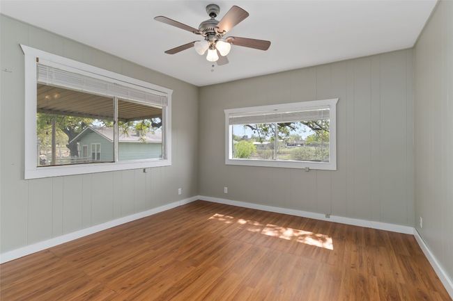 Unfurnished room with baseboards, ceiling fan, and wood finished floors | Image 15