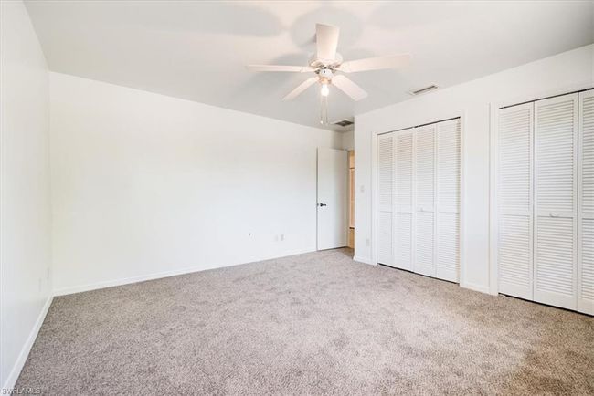 Unfurnished bedroom featuring visible vents, baseboards, multiple closets, and carpet floors | Image 20