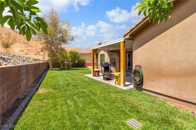 View of yard featuring a patio area and a fire pit | Image 40