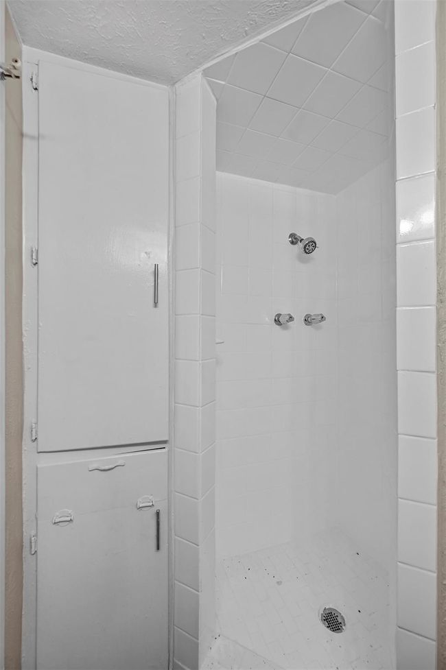 Bathroom featuring a stall shower and a textured ceiling | Image 15
