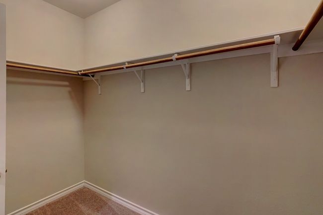Walk in closet with carpet floors | Image 14