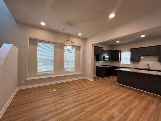 Kitchen featuring stainless steel appliances, light wood-style floors, baseboards, and recessed lighting | Image 6