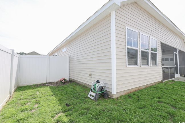 View of side of home featuring a lawn and a fenced backyard | Image 28