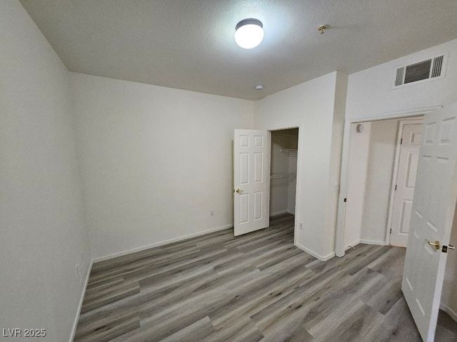 Unfurnished bedroom featuring a closet, wood finished floors, visible vents, and baseboards | Image 29