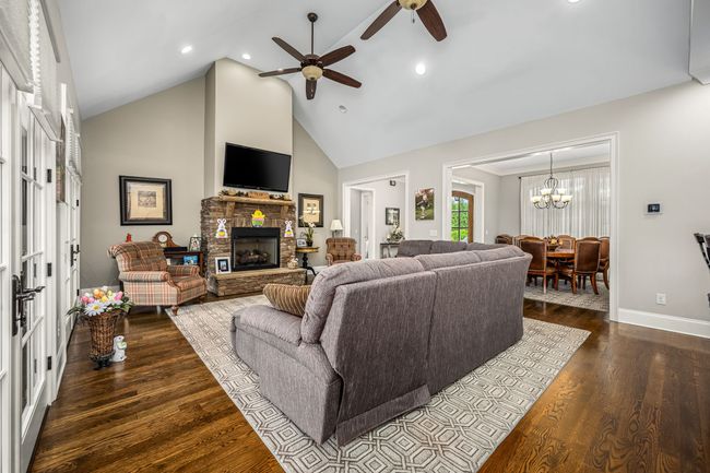 Imagine stepping into a beautifully spacious family room, where the warm glow of a gas log fireplace instantly creates an inviting atmosphere. | Image 37