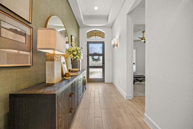Foyer entrance with light wood-style flooring and a raised ceiling | Image 4