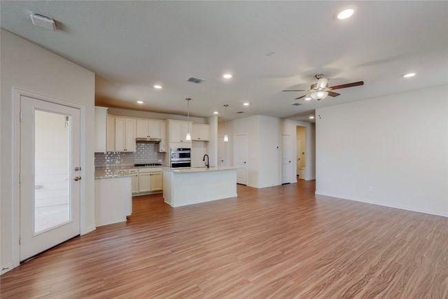 Kitchen with a sink, open floor plan, light wood finished floors, and recessed lighting | Image 4