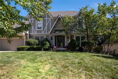 Tudor house with a front lawn and a garage | Image 2