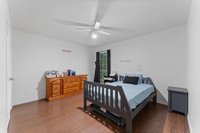 Bedroom with wood finished floors and a ceiling fan | Image 23