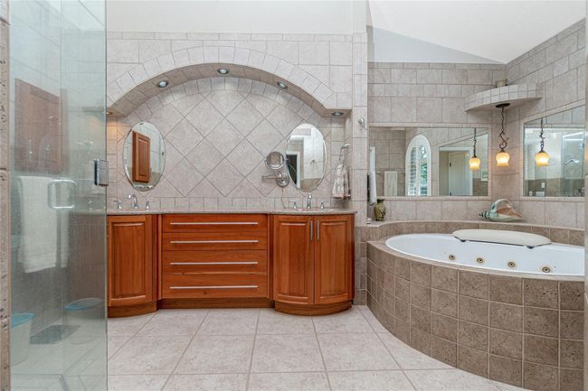 Luxurious bathroom with 10' x 16' jacuzzi tub, towel warmer drawer in dual sink wood vanity | Image 40
