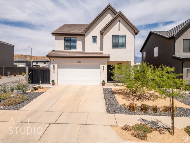 View of front facade with fence, concrete driveway, a tiled roof, stucco siding, and a garage | Image 62