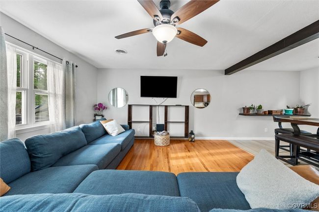 Living area featuring wood finished floors, visible vents, a ceiling fan, and baseboards | Image 11